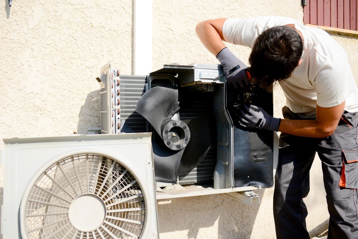 Electrician Installer Working on Compressor Unit Air Conditioner