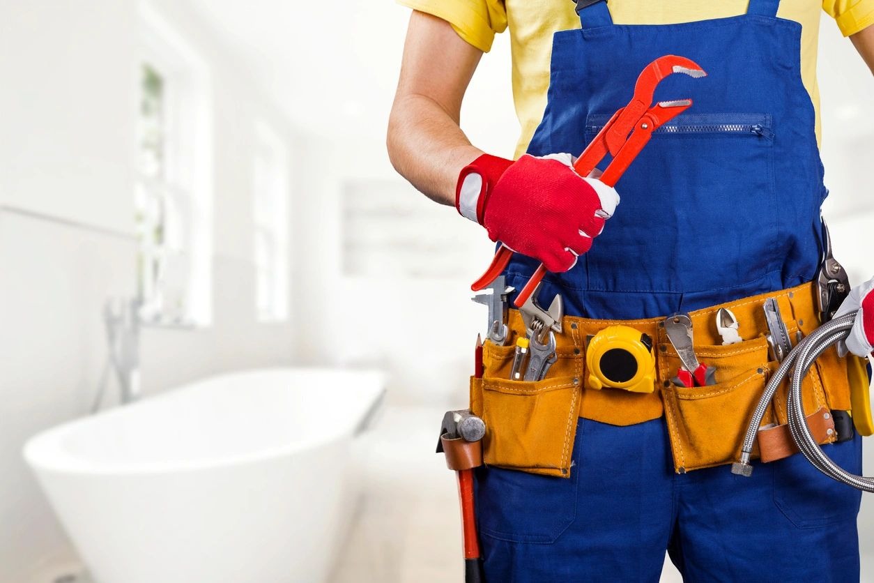 Plumber With Tool Belt and Wrench in Hand